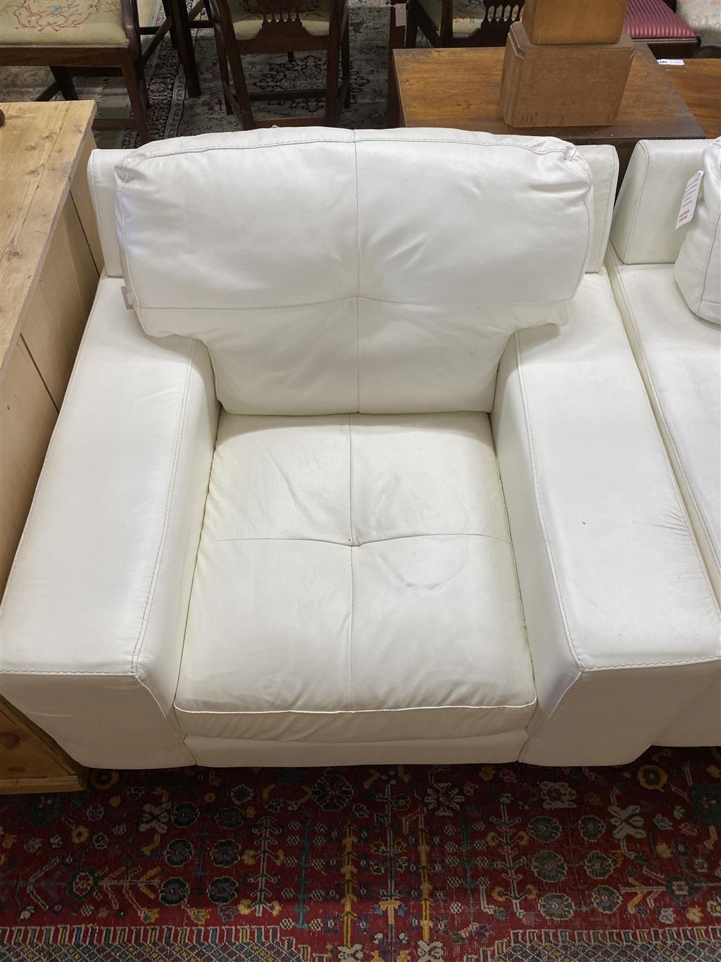 A pair of contemporary white leather armchairs, width 104cm, depth 98cm, height 88cm